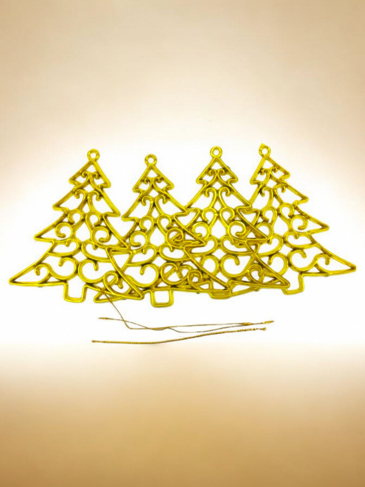 Four yellow Christmas tree decorations with a geometric pattern, placed against a light background