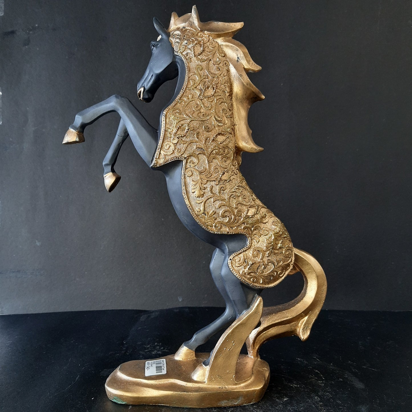 Gold dressed horse standing on two showpiece