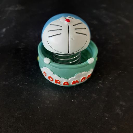Doramon sitting In a basket bubble head showpiece