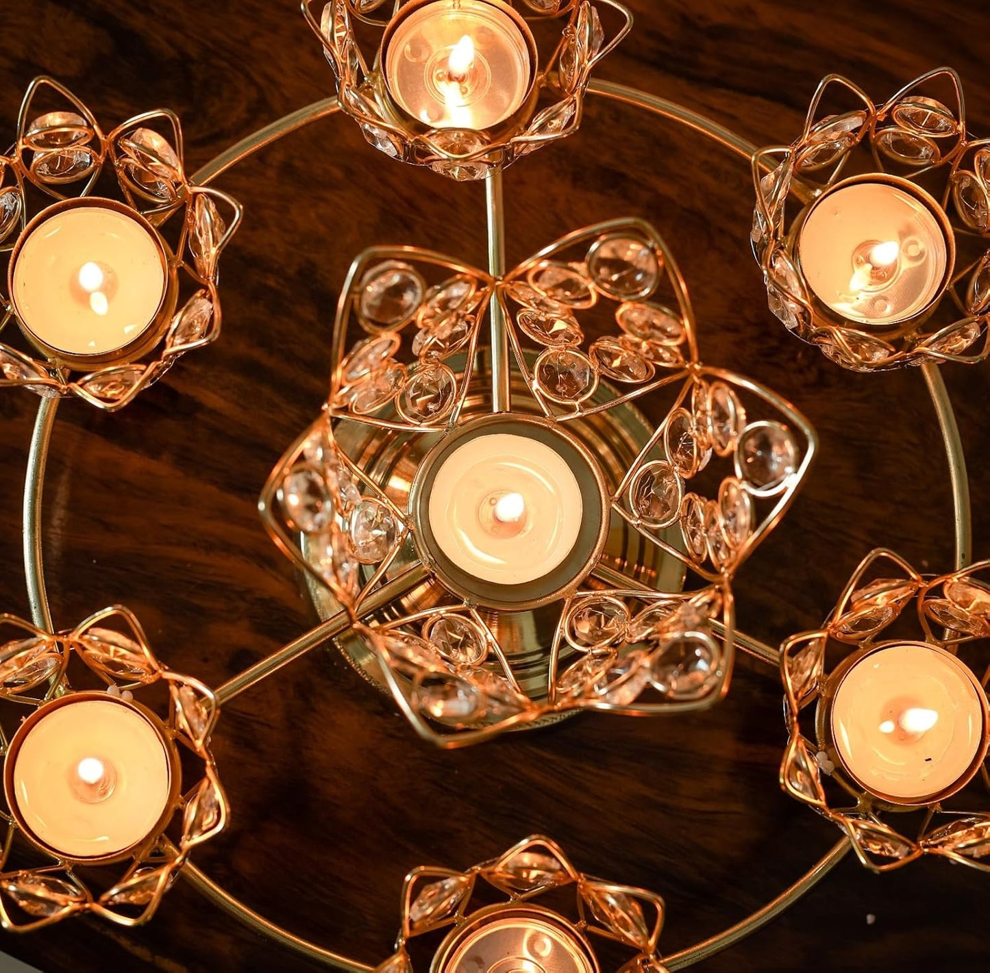 Decorative candle holders with candles on a wooden surface
