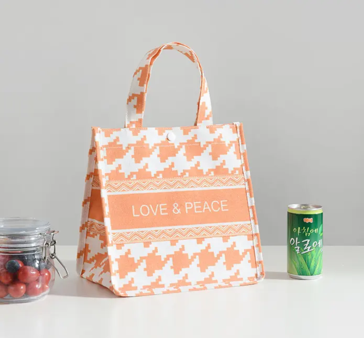 Patterned tote bag with 'Love & Peace' text on a light gray background