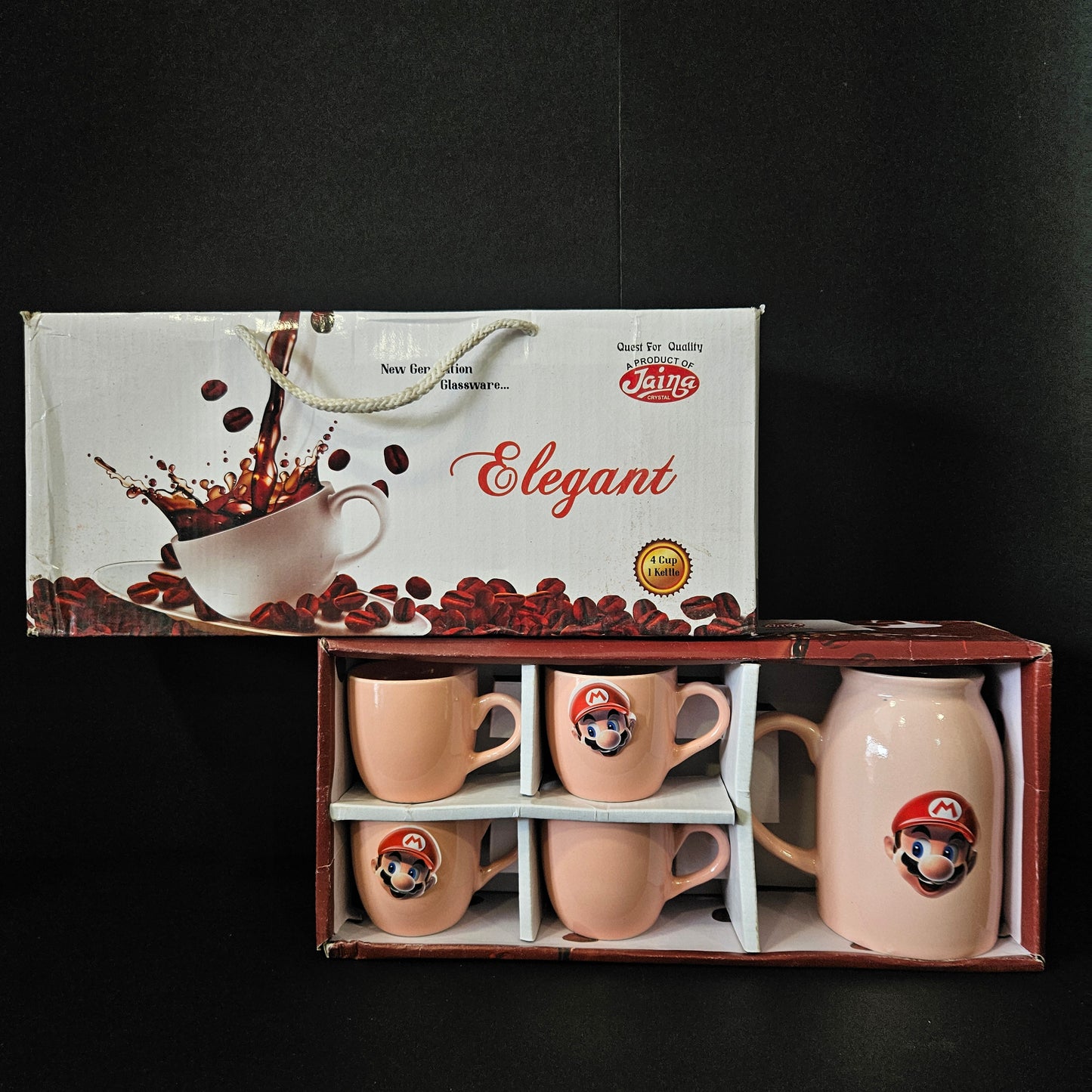 Set of four ceramic mugs with a decorative design in a wooden box, next to an Elegant branded box on a black background.