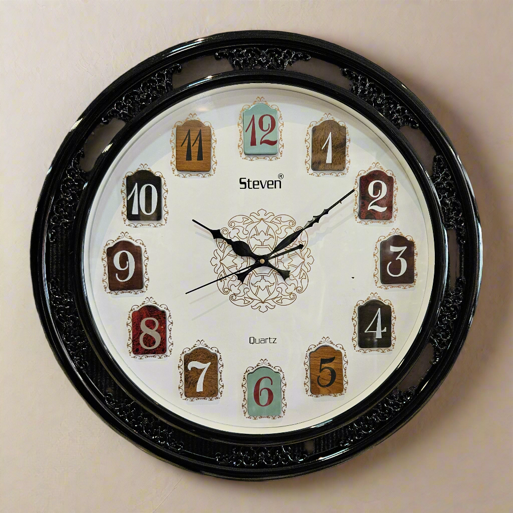 Wall clock with decorative black frame on a dark textured background