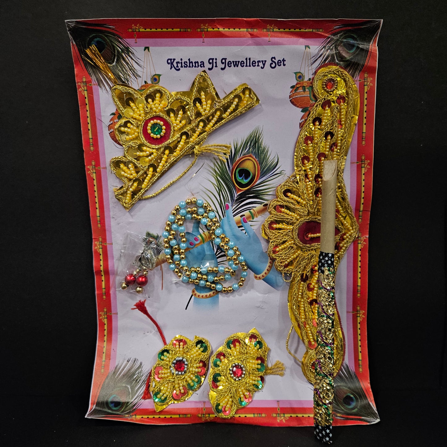 Decorative jewelry set with peacock design on a black background