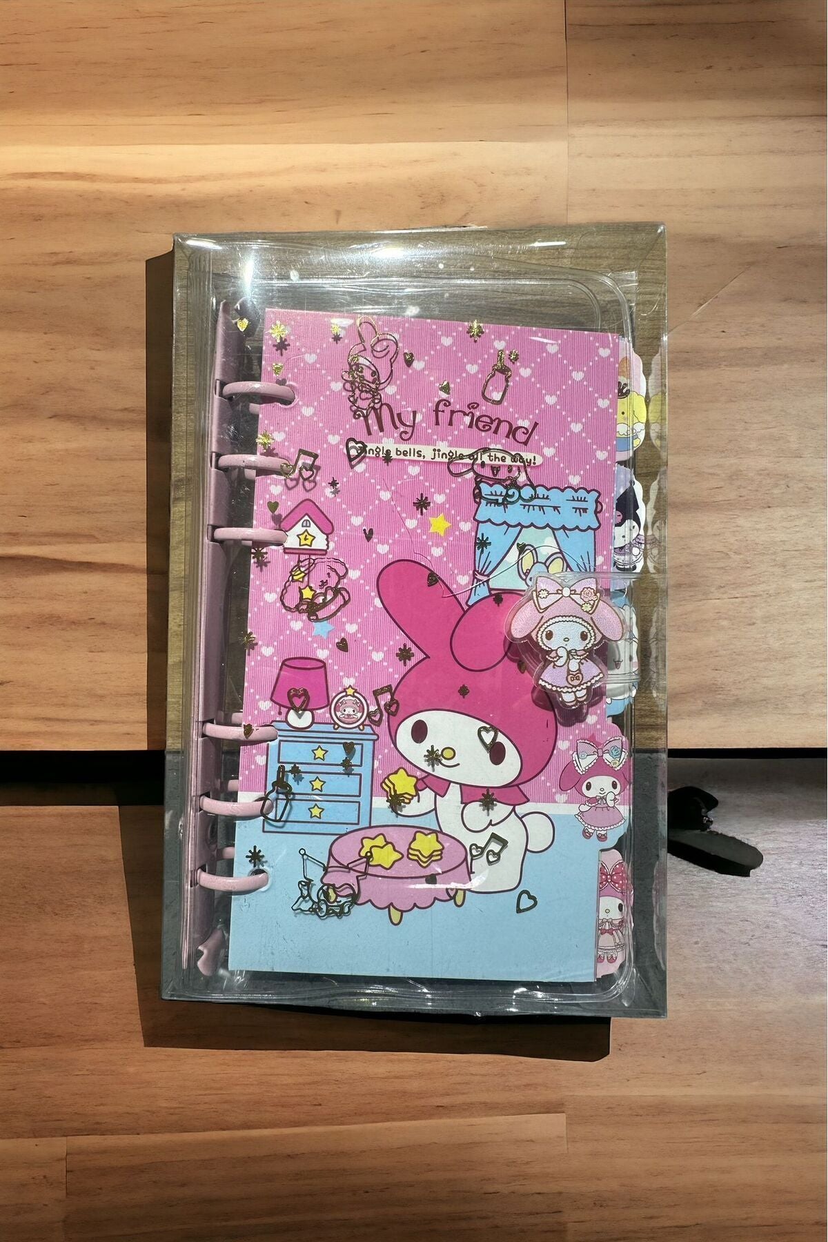 My Friend Jingle bells, jingle all the way!" appears on a notebook featuring a character resembling My Melody from Sanrio.