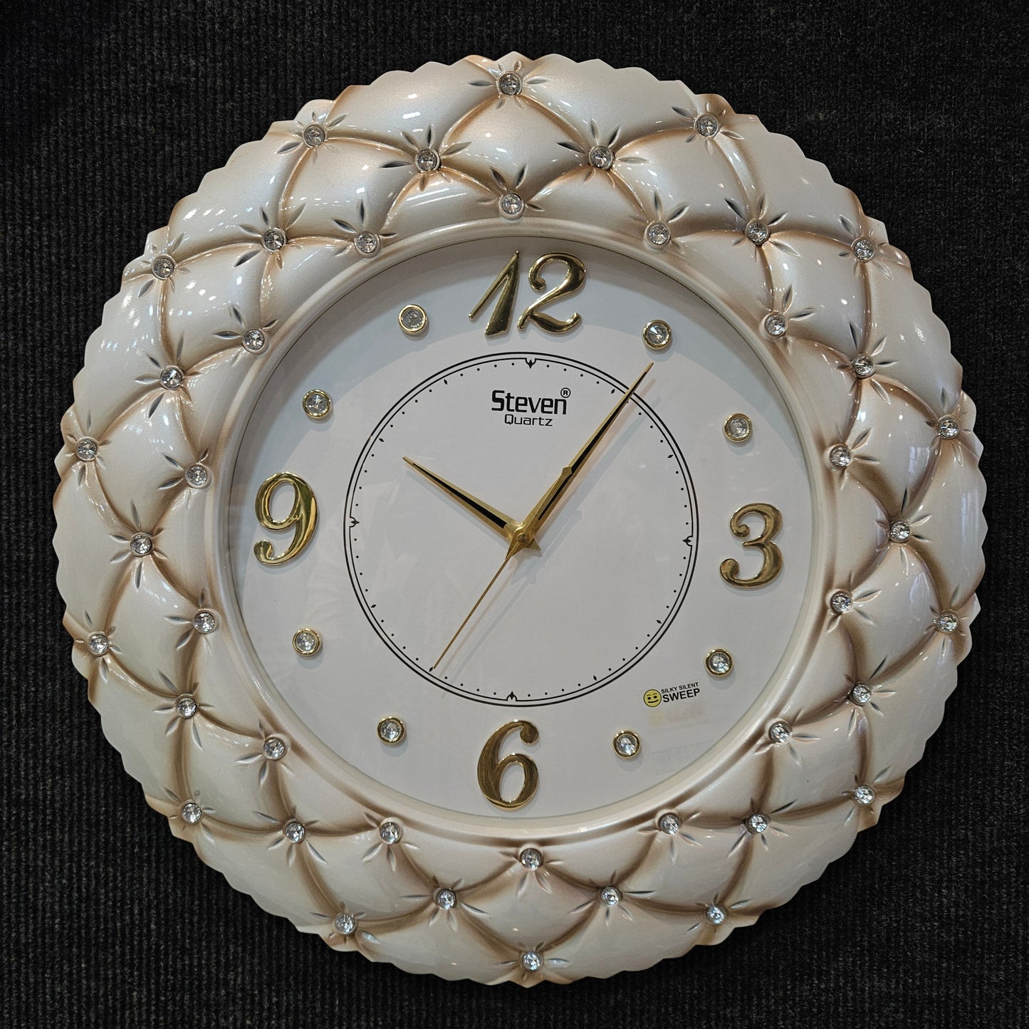 Decorative wall clock with intricate design on a dark background