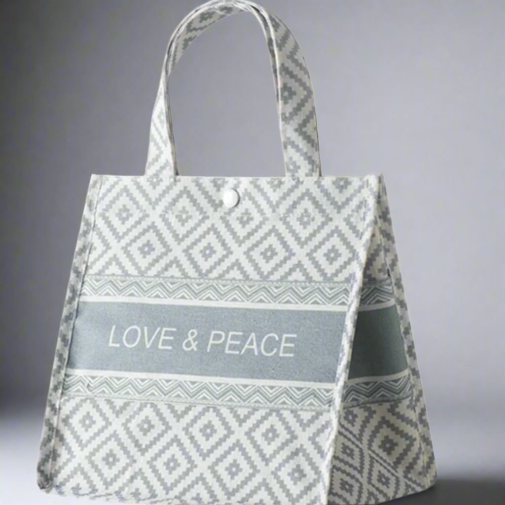 Tote bag with 'Love & Peace' text and geometric pattern on a white background