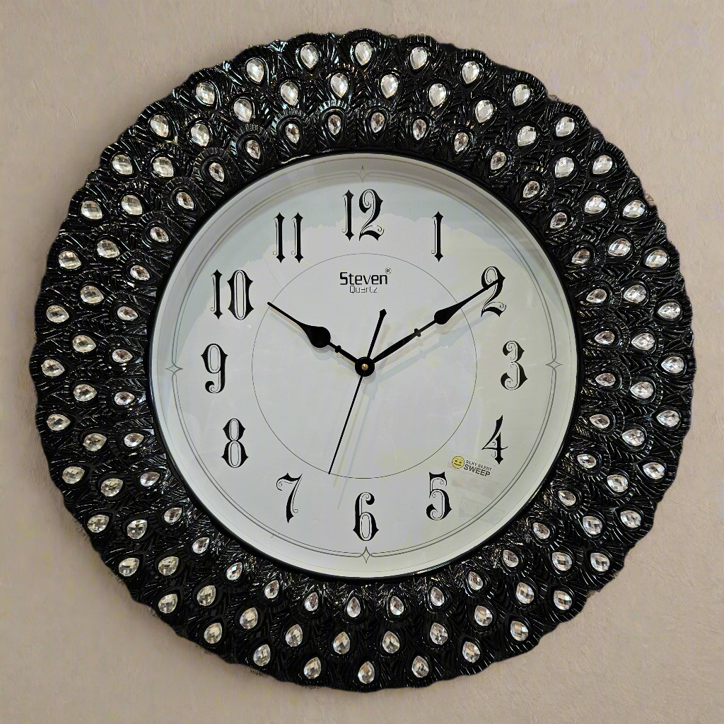 Decorative wall clock with black and silver design on a dark background