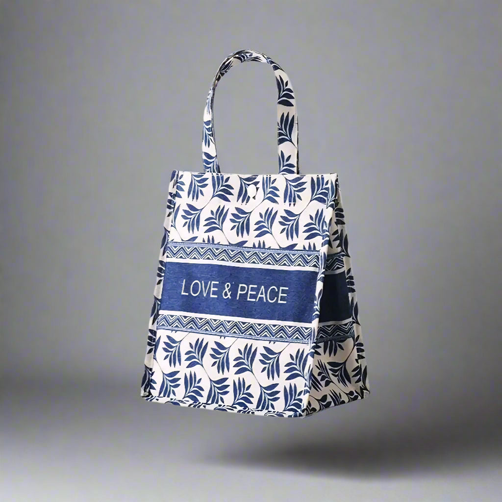 Tote bag with blue and white leaf pattern and 'LOVE & PEACE' text on a white background