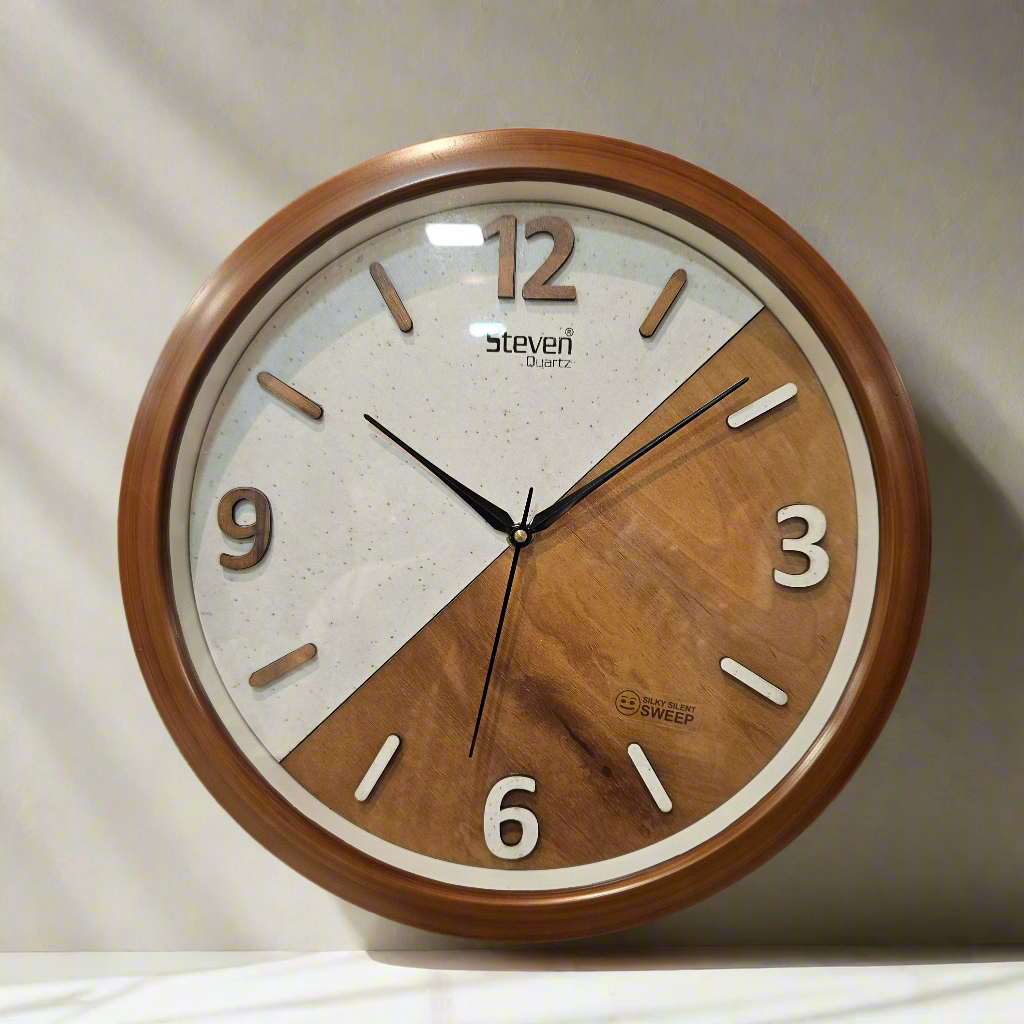Wooden wall clock with a two-tone design on a dark background