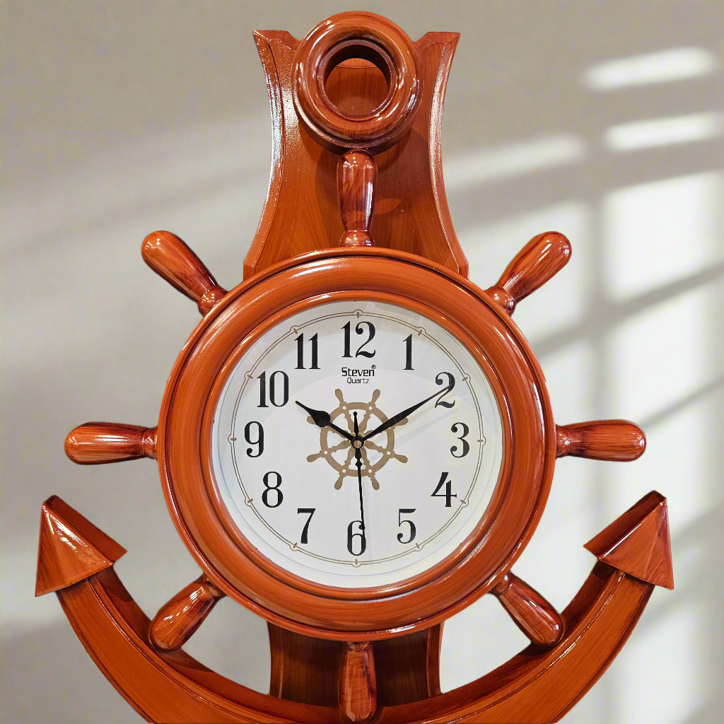 Wooden wall clock with ship's wheel design on a dark background