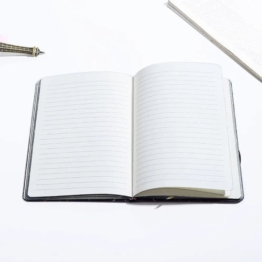 A5-sized notebook or diary with a hardcover featuring an astronaut design.