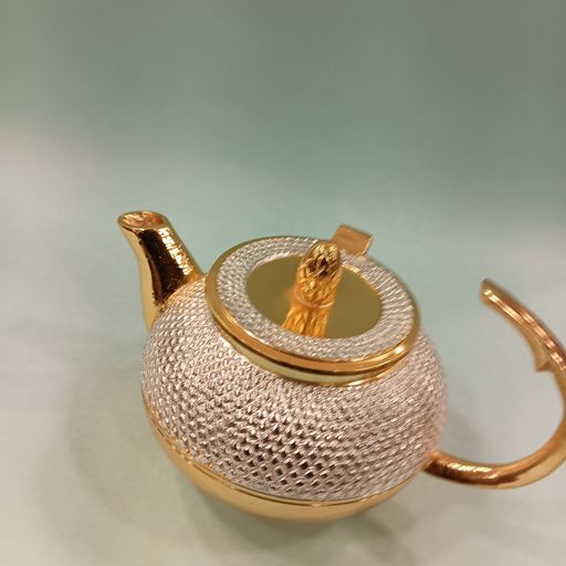 Sliver and gold tea can