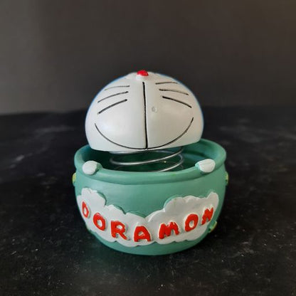 Doramon sitting In a basket bubble head showpiece