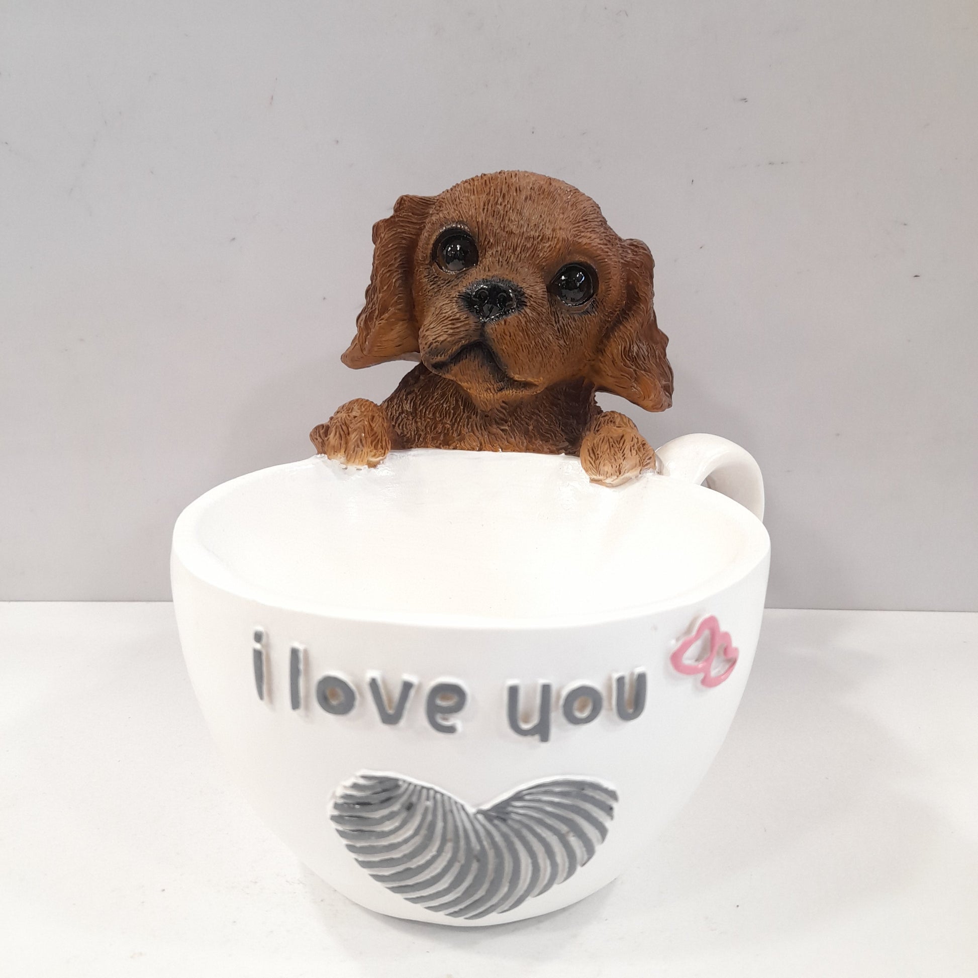 Puppy holding a coffee cup showpiece