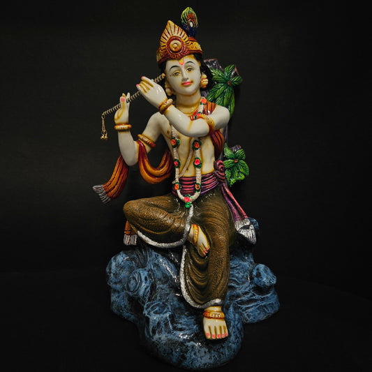 Decorative lord Krishna murti playing flute sitting on stone for Home Decor