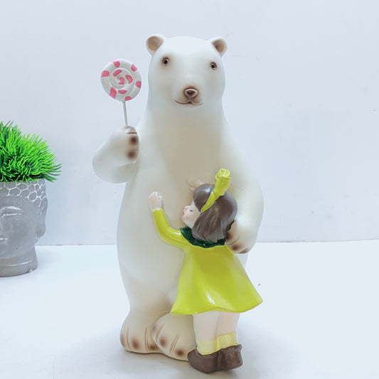 A bear hugs a baby, with a lollipop in his paw