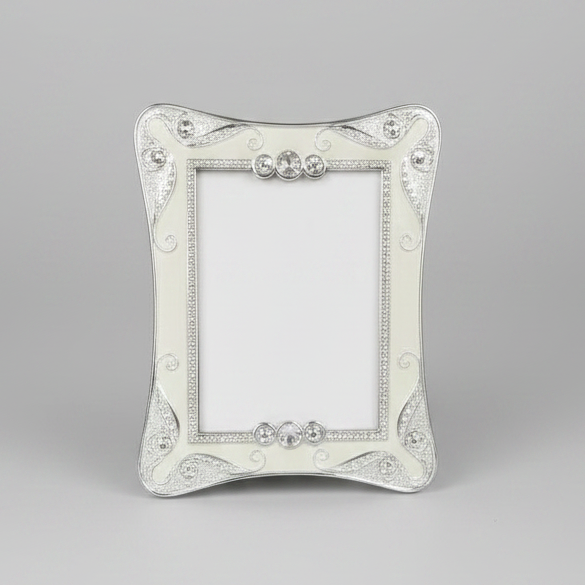 A silver-colored metal photo frame with a couple kissing in an intimate setting displayed inside.