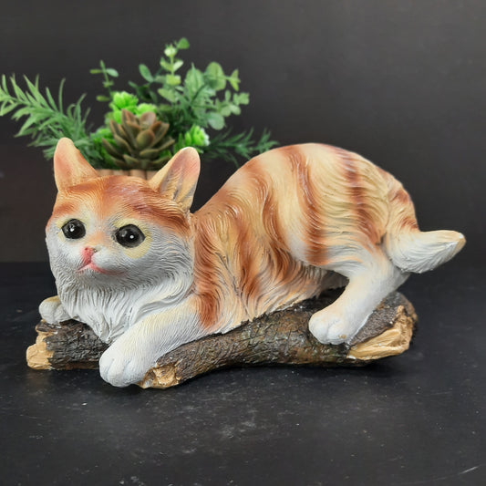 Cute little kitty sitting on tree stem