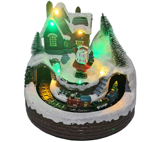Christmas-themed miniature scene with a house, trees, and train on a white background