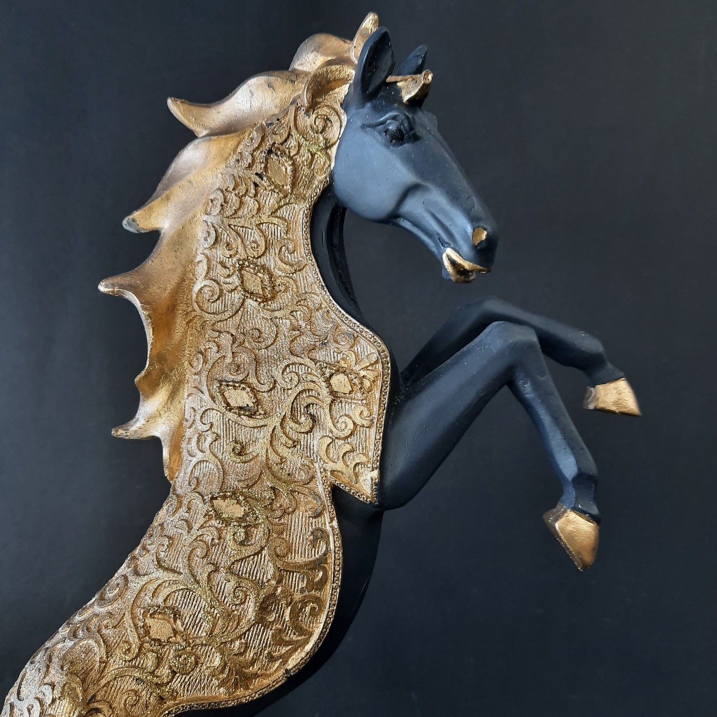 Gold dressed horse standing on two showpiece