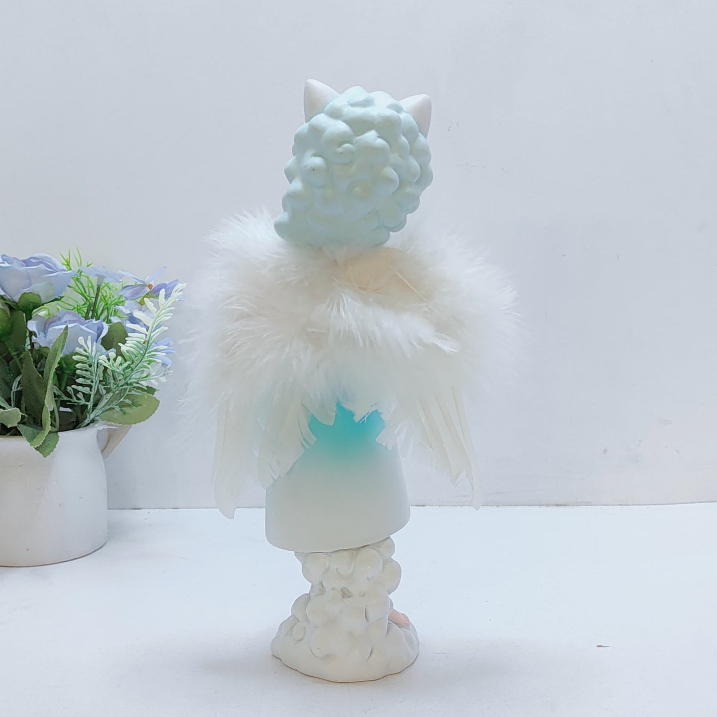 Angel girl with ears or horns on a cloud wings feather