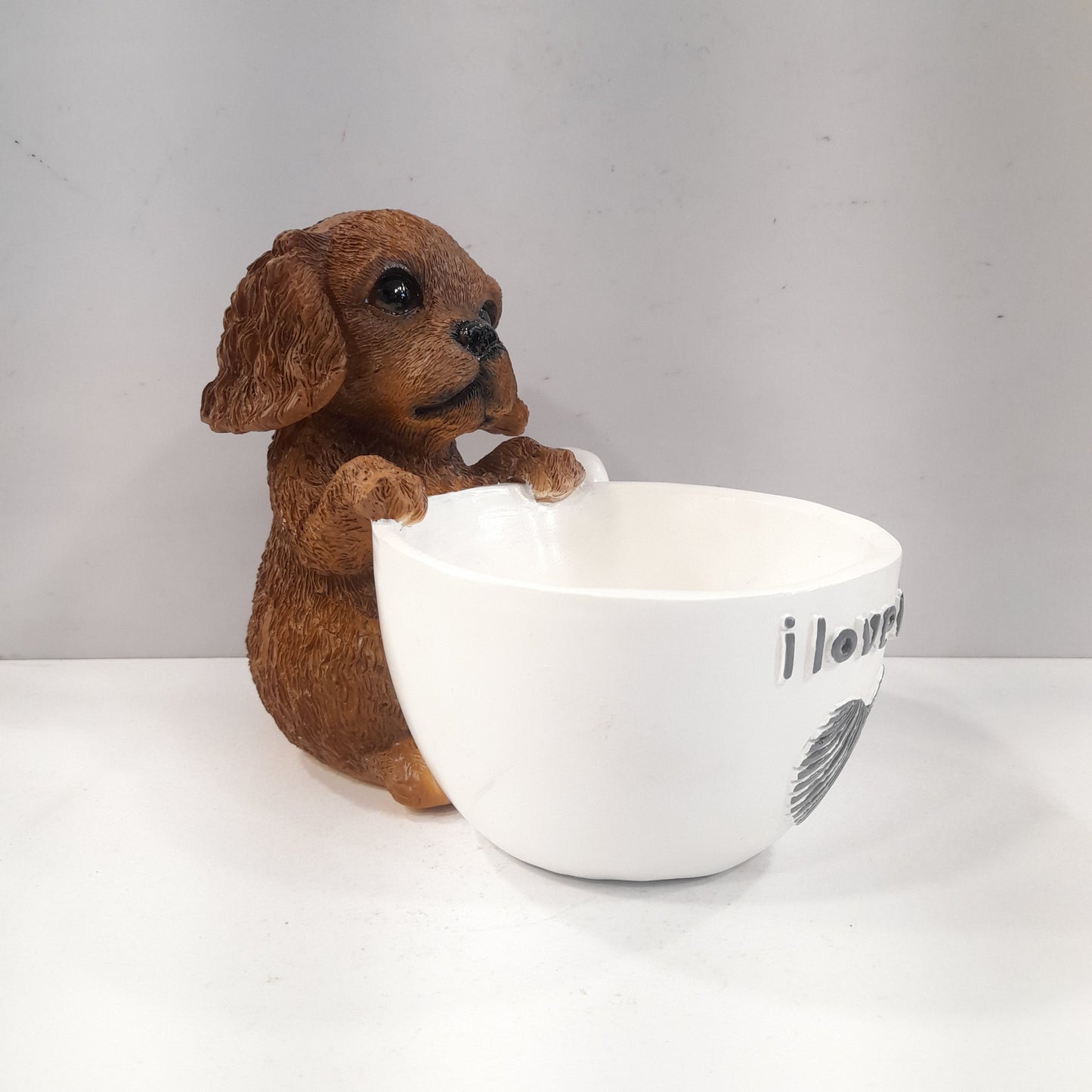 Puppy holding a coffee cup showpiece
