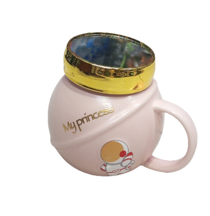 pink mug with a golden lid, featuring an astronaut design and the text "My princess". The mug is likely a novelty item or a gift,  children or those who appreciate cute designs.