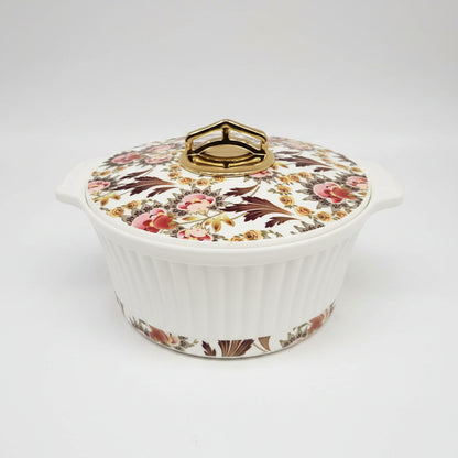 Decorative ceramic dish with floral lid on a white background