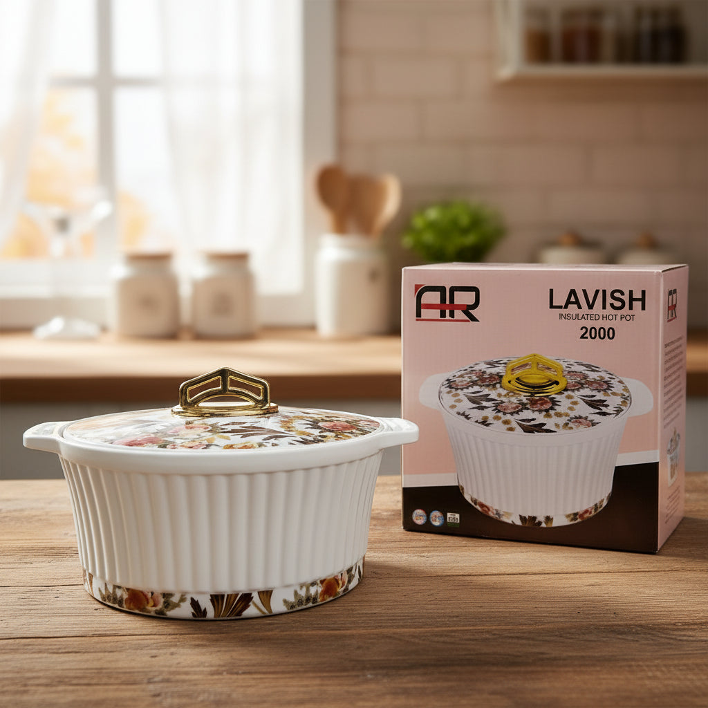White ceramic pot with floral design and gold handle next to its packaging box on a wooden surface.