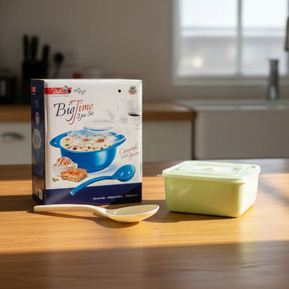 Green container with a lid next to a packaging box for a cooking set on a white background