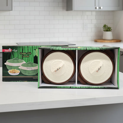 Two ceramic bowls in a box with a green and white label on a gray background