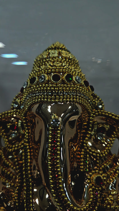 Lord vinayaka 24 carats gold Plated idol Decorated with attractive stones in a transparent protective cabin