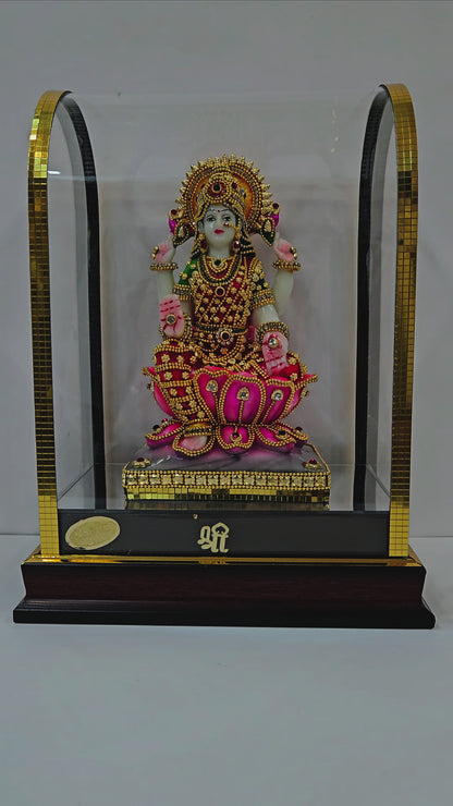 Lakshmi mata 24carats gold Plated idol Decorated with attractive stones in a transparent protective cabin