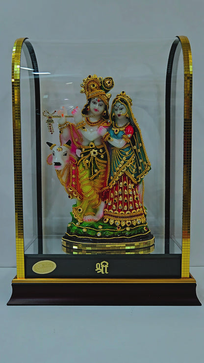 24 carats gold Plated radha Krishna Idol Decorated with attractive stones designed Statue showpiece in transparent protective cabin