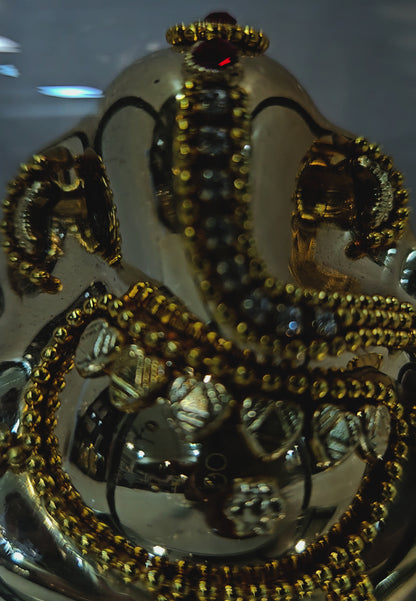 Lord vinayaka murti in a attractive look Decorated with stones designed in a transparent protective cabin