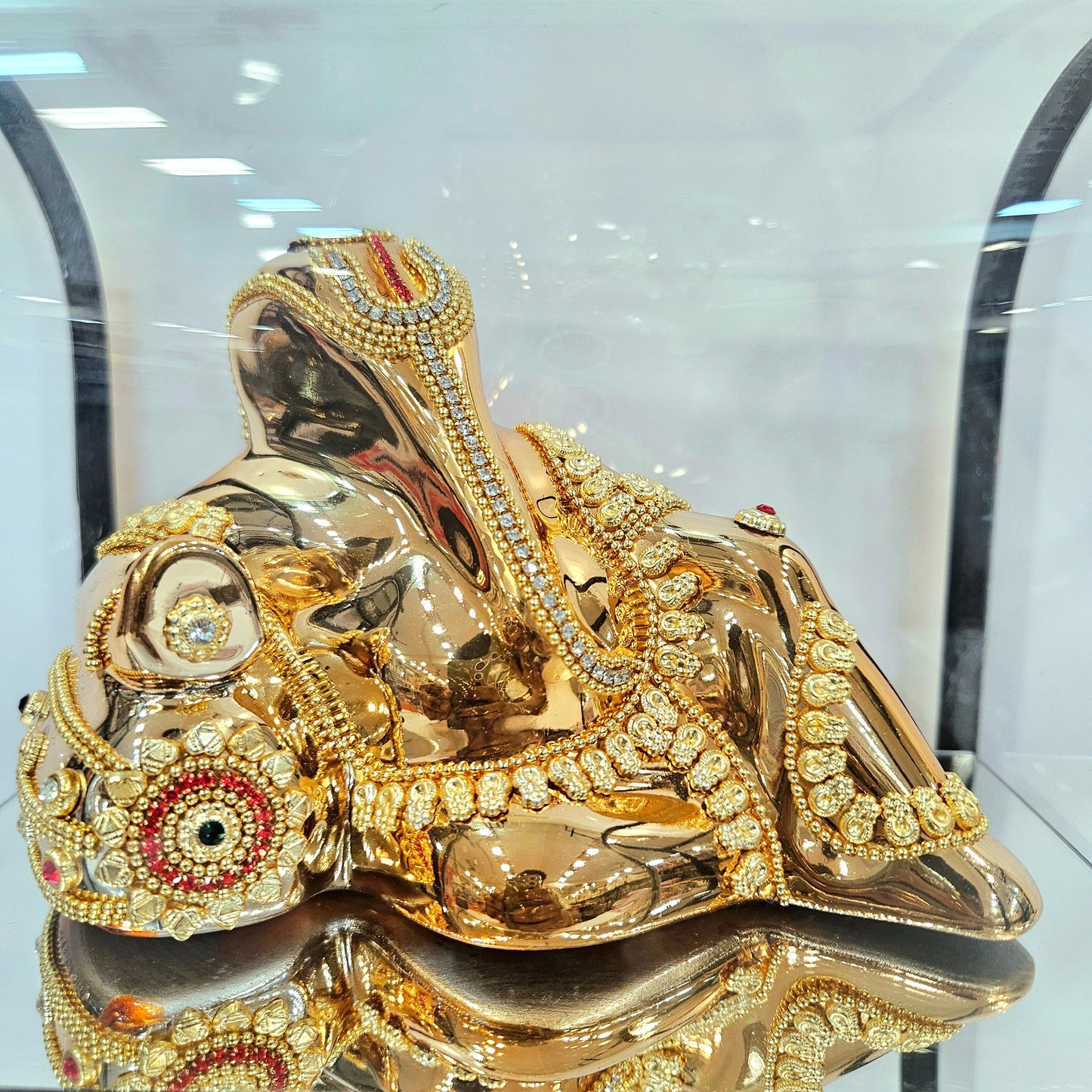 Lord Vinayaka murti 24carats gold Plated idol with attractive stones designed Statue in a transparent protective cabin