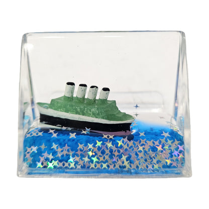 Green and black Titanic liquid motion showpiece is a decorative accent for tabletops or car dashboards, featuring a miniature ship that floats in blue liquid