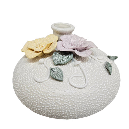 Handcrafted ceramic floral vase, an elegant decorative piece characterized by its unique texture and delicate relief work