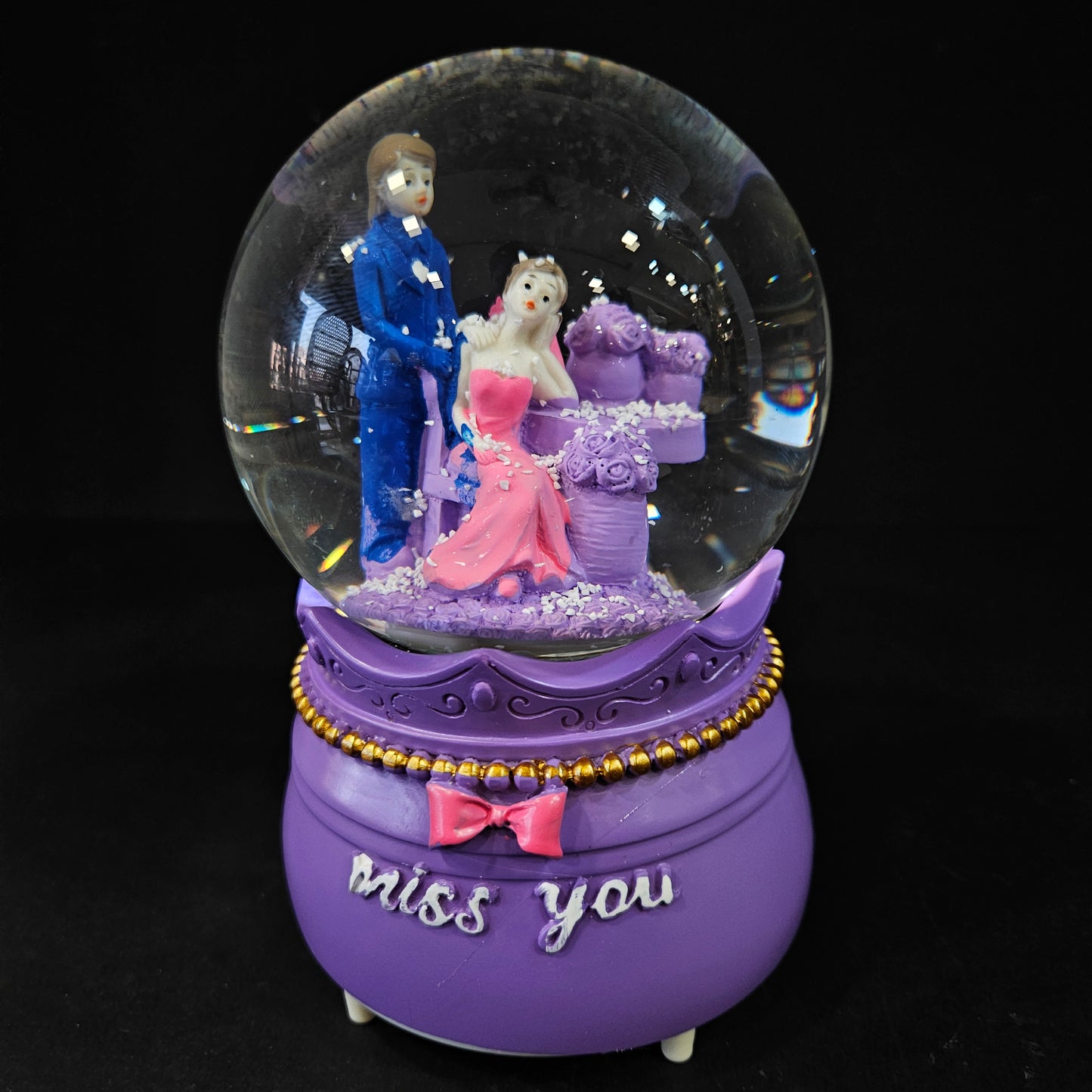 Good looking love Couple missing eachother in a glass dom with multi colour lighting & snow effect