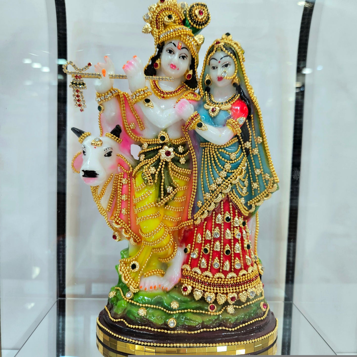 24 carats gold Plated radha Krishna Idol Decorated with attractive stones designed Statue showpiece in transparent protective cabin