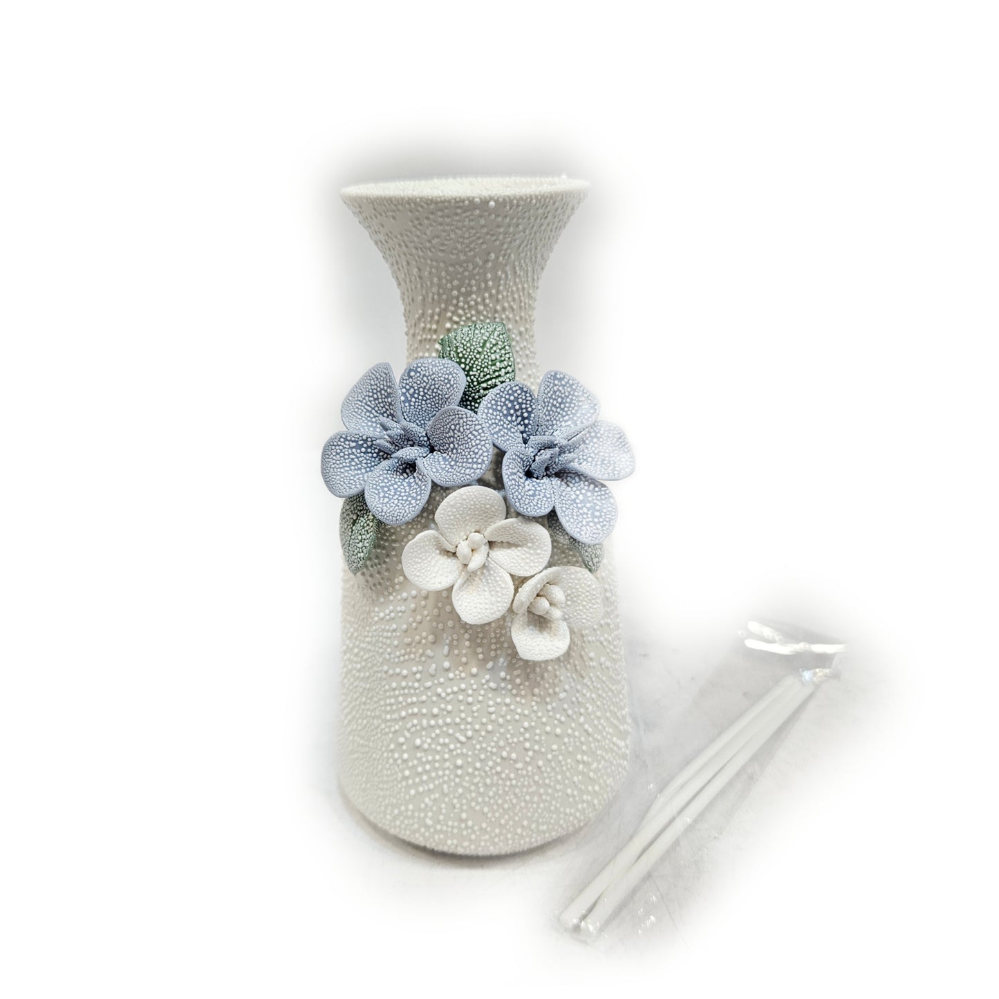water droplets textured ceramic vase with light blue and white flowers vase