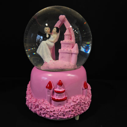Beautiful married couple with Castle themed multi colour lighting snow Globe