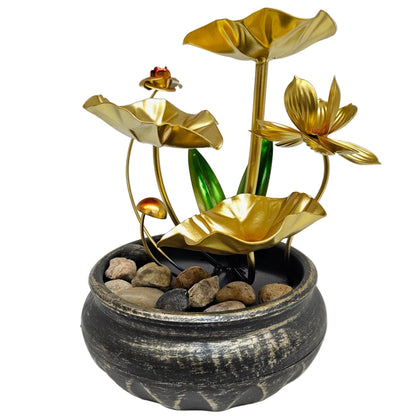 Metal lotus tabletop water fountain features a golden three-tier design with green leaves and natural river rocks