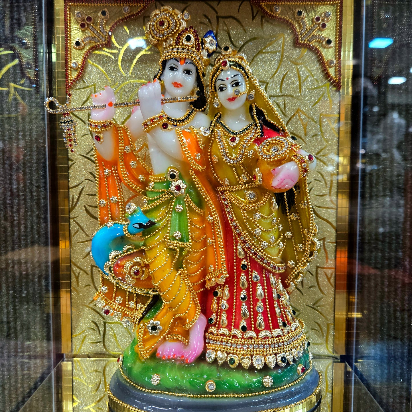 24 carat gold Plated radha Krishna Idol Statue Decorated with attractive stones design transparent protective cabin