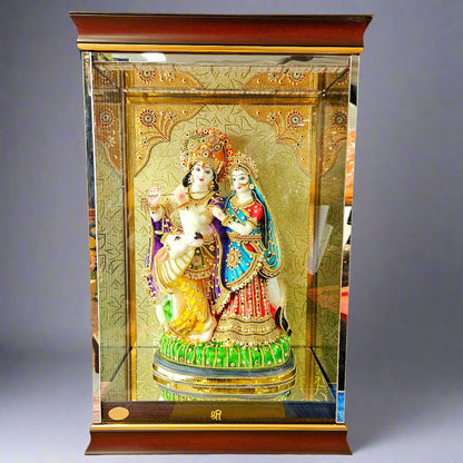 gold Plated radha Krishna Decorated with stones work idol Statue in a transparent protective cabin