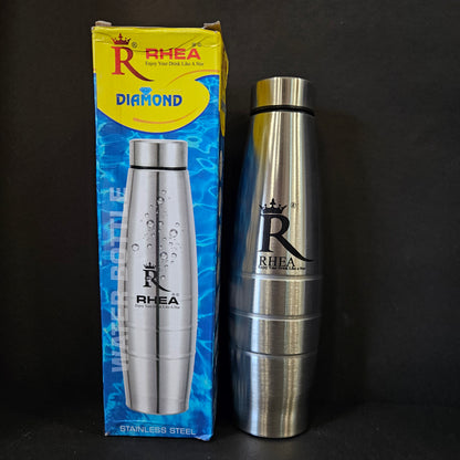 Silver and gold bottle with 'Rhea' branding on a black background