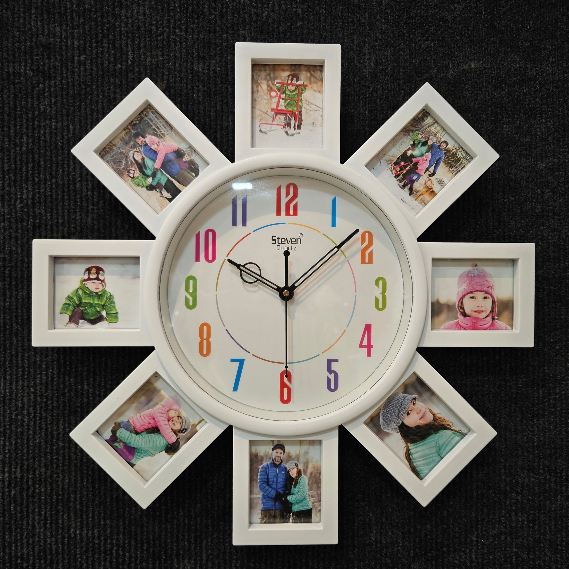 Decorative wall clock with multiple photo frames around it on a dark background