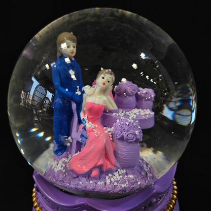 Good looking love Couple missing eachother in a glass dom with multi colour lighting & snow effect