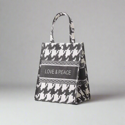 Tote bag with houndstooth pattern and 'LOVE & PEACE' text on a white background